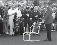  ?? AP/ CURTIS COMPTON ?? Augusta National Chairman Billy Payne ( right) leads a moment of silence for Arnold Palmer, with Palmer’s green jacket placed in his empty chair, before Gary Player ( center) and Jack Nicklaus ( second from right) tee off during the honorary start of...