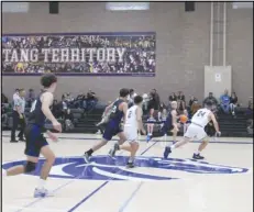  ?? JOHN SANDERS/Valley Press Sports Correspond­ent ?? Desert Christian’s Luke Dumas (second from right) dribbles the ball down the court against Vasquez in a Heritage League game on Thursday at Vasquez High School.