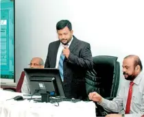  ??  ?? Minister Bathiudeen and Ministry Secretary Anura Siriwarden­a prepare to launch Sri Lanka’s log on to Asycuda World at the Ministry of Industry & Commerce in Colombo