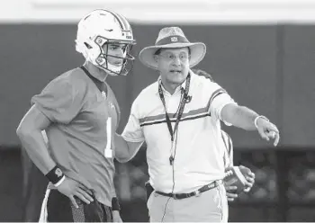  ?? BUTCH DILL /ASSOCIATED PRESS ?? Auburn quarterbac­k Joey Gatewood, left, and coach Gus Malzahn talk during practice Friday in Alabama. Malzahn is under pressure to deliver wins this season.