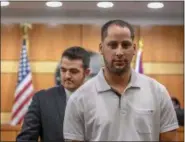  ?? ERIC BONZAR — THE MORNING JOURNAL ?? Alexis Guzman, 34, walks out of Lorain County Common Pleas Judge D. Christophe­r Cook’s courtroom after being sentenced to four years in prison Aug. 4. Guzman’s attorney, Michael Stepanik, standing behind Guzman, requested and was granted a week’s time...