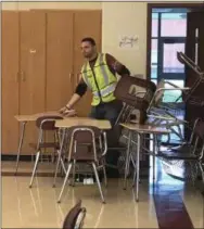  ?? GINGER RAE DUNBAR – DIGITAL FIRST MEDIA ?? An Oxford police officer who portrays the suspect during an active shooter drill enters the classroom with a fake knife while teachers exit through a back door.