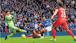  ??  ?? On target: Alfredo Morelos opens the scoring and (right) Sheyi Ojo (centre) celebrates netting his side’s second goal