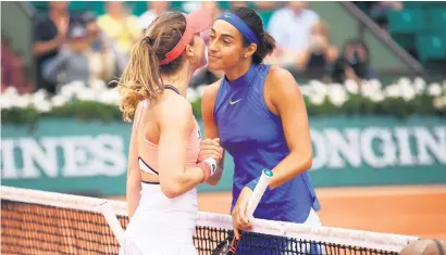  ?? Picture: Getty Images ?? JUST FOR THE FANS. Caroline Garcia of France shares a kiss with compatriot Alize Cornet following her victory in the French Open fourth round at Roland Garros in Paris on Monday.