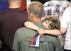  ??  ?? A girl rests with a small Trump flag at the rally in Harrisburg,