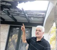  ?? PICTURES: DUNCAN GUY ?? HELL HOLE: Robert Stanton shows damage to the roof of his Carrington Heights home that he has had to live with since the storm of October 10.
