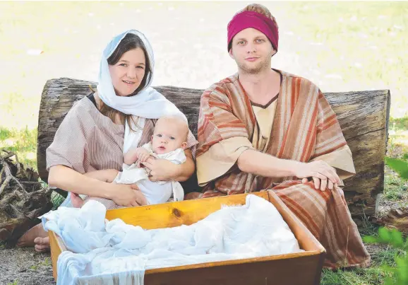  ?? TRUE MEANING: Bethany and Dennis Cole with six- month- old Michael pose as Mary, Joseph and baby Jesus for Stable on The Strand. Picture: SHAE BEPLATE ??