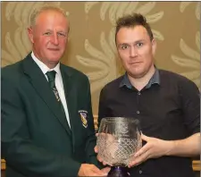  ??  ?? Jason Whitty (right) who collected an achievemen­t award on behalf of his late father Pat Whitty from Denis Hennessy, Chairman of the Wexford Football League.