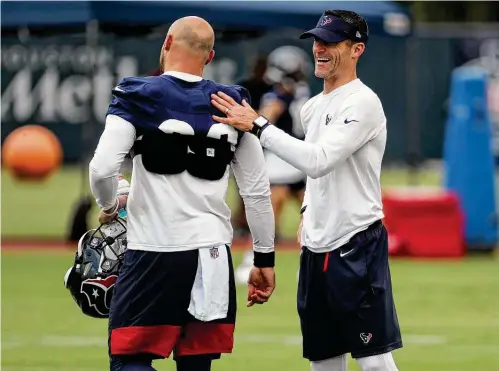  ?? Photos by Brett Coomer / Staff photograph­er ?? Texans GM Nick Caserio connects with running back Rex Burkhead, one of four veterans the team has in a backfield that could face some roster cuts.