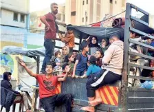  ?? REUTERS ?? Uncertain times: People flee Rafah, after the Israeli military began evacuating Palestinia­n civilians from the city on Monday.