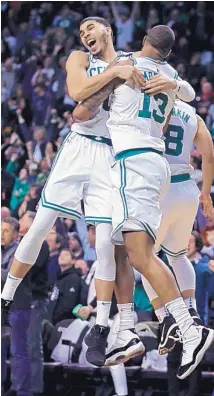 ?? CHARLES KRUPA/ASSOCIATED PRESS ?? Boston’s Marcus Morris (13) leaps into the arms of Jayson Tatum as they celebrate Morris’ game-winning 3-point shot with 1.2 seconds left against Oklahoma City on Tuesday night.