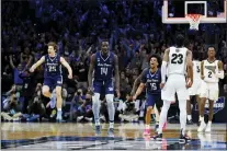  ?? CHRIS SZAGOLA — THE ASSOCIATED PRESS ?? From left, Saint Peter’s Doug Edert, Hassan Drame and Matthew Lee celebrate after beating Purdue on Friday at the Wells Fargo Center.