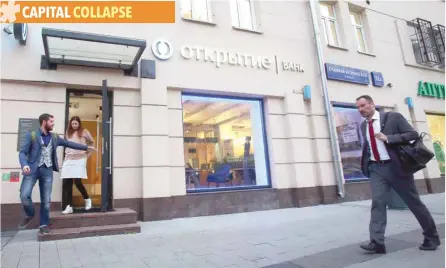  ?? — Reuters ?? People walk past Russian bank Otkritie in Moscow.