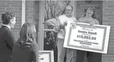  ?? KYLE ROBERTSON/ COLUMBUS DISPATCH ?? Howie Guja and Loren Williams, from the Publishers Clearing House Prize Patrol, surprise Sandra Staudt and her husband, Charlie, at their house in Galloway.