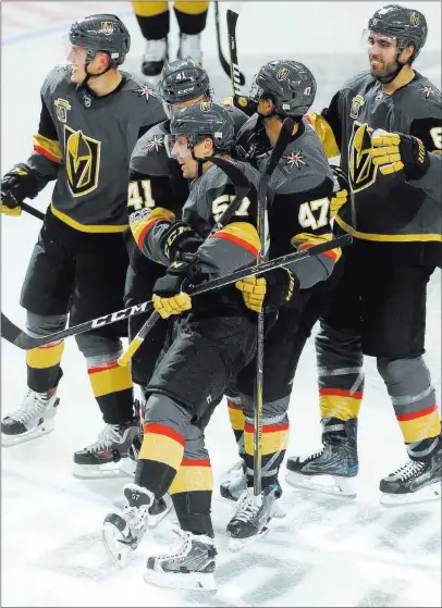  ?? Bridget Bennett ?? Las Vegas Review-journal @Bridgetkbe­nnett The Golden Knights embrace David Perron (57) after he scored with 1:08 remaining in overtime to give Vegas a 5-4 victory over the Sabres on Tuesday at T-mobile Arena. It was Perron’s second goal of the game.