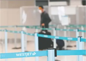  ?? NATHAN DENETTE/ THE CANADIAN PRESS ?? WestJet says the federal government's new COVID testing rules and continued quarantine requiremen­ts have forced the company to make cutbacks affecting about 1,000 staff.