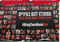  ?? ?? CALL Poster in Jerusalem with photos of Israeli hostages