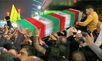  ?? Khalid Mohammed/The Associated Press ?? Mourners carry the coffin of Iran’s top general, Qassem Soleimani, on Saturday during his funeral in Karbala, Iraq.