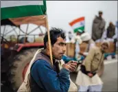  ?? (File Photo/AP/Altaf Qadri) ?? A farmer smokes a bidi, or hand-rolled cigarette, Jan. 7 during a tractor rally to protest new farm laws in Ghaziabad on the outskirts of New Delhi, India.