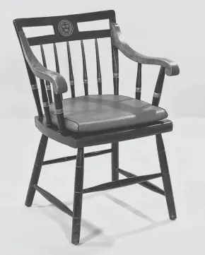  ?? PROVIDED ?? This midcentury Windsor style chair features the crest and colors of Harvard University. It sold for $438, more than twice its estimate, at a Bonhams Skinner auction.