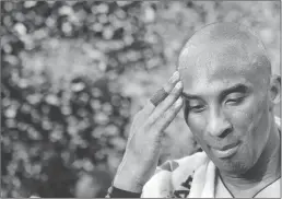  ?? Tribune News Service/los Angeles Times ?? The Los Angeles Lakers’ Kobe Bryant pauses for a moment as confetti streams down after his final game, on Wednesday, April 13, 2016, at Staples Center in Los Angeles. Bryant scored 60 points in a 101-96 victory against the Utah Jazz.