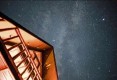  ?? — aFP ?? Myanmar: a long exposure picture showing the Milky Way above a building in Kalaw, a hill town in the Shan state.