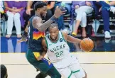  ?? ROSS D. FRANKLIN/ASSOCIATED PRESS ?? Milwaukee’s Khris Middleton (22), one of three soon-to-be Olympians playing in the NBA Finals, drives on Phoenix’s Deandre Ayton on Saturday.