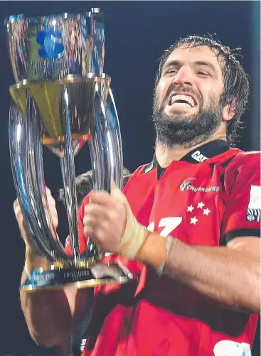  ?? Picture: AFP PHOTO/MARTY MELVILLE ?? TIGHT: Crusaders captain Sam Whitelock, pictured celebratin­g with the Super Rugby trophy last year, says the squad has rallied together after last week’s shooting.