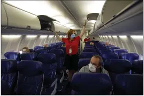  ?? (AP) ?? A Southwest Airlines flight attendant prepares a plane for takeoff in May at Kansas City Internatio­nal Airport in Kansas City, Mo. The airline plans to begin offering service between Little Rock and Atlanta.