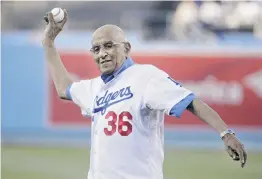  ?? PHOTO: AP ?? Old timer . . . Baseball great Don Newcombe throws the ceremonial first pitch before a game between the Los Angeles Dodgers and the Cleveland Indians in Los Angeles in 2014.