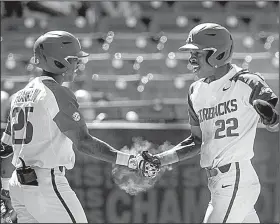  ?? NWA Democrat-Gazette/BEN GOFF ?? Freshman Christian Franklin (left) congratula­tes teammate Curtis Washington after Washington scored in the eighth inning of Arkansas’ victory over Mississipp­i on Wednesday at the SEC Tournament in Hoover, Ala.