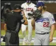  ?? Associated Press ?? BLOWING AWAY — Los Angeles Dodgers starting pitcher Clayton Kershaw talks with home plate umpire Cory Blaser during the first inning in Game 4 of the National League Championsh­ip Series against the Atlanta Braves on Thursday in Arlington, Texas. The Dodgers trailed the Braves 7-1 in the seventh at press time.