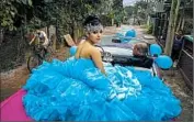  ?? RAMON ESPINOSA/AP ?? Daniela Santos Torres, 15, waits in a classic car with her father for a ride to her quinceaner­a party near Havana.
