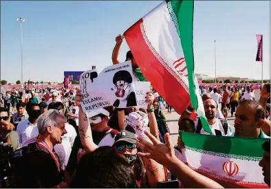  ?? AP Photo/Jin-Man Lee ?? Protesters and supporters of the Iranian soccer team clash at a World Cup match in Qatar on Friday.