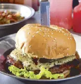  ??  ?? Take a bite: The Big B burger patty is made of 50-percent beef and 50-percent bacon.