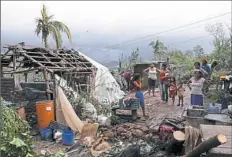  ?? Marco Ugarte/Associated Press ?? A family stands near their damaged home Wednesday in the aftermath of Hurricane Willa in Escuinapa, Mexico.