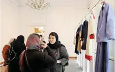  ?? ?? Visitors, including fashion and clothing designers, visit the annual exhibition on fashion and clothes designed by young Iranian designers, at the Sadabad Palace Complex, north of the Iranian capital Tehran.