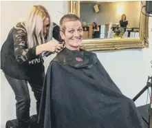  ??  ?? Carole Pickersgil­l has her hair shaved off in aid of the garden appeal for her granddaugh­ter Millie Fountain.