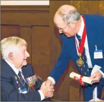  ??  ?? Donald Hunter, Stanley Hodge and Ivan Jennings receiving their medals