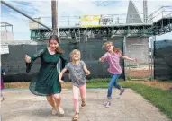  ??  ?? Mallory Yarbrough, Evelyn Hill and Reina Holcombe play next to the new First Baptist Church that is being built by the North American Mission Board.