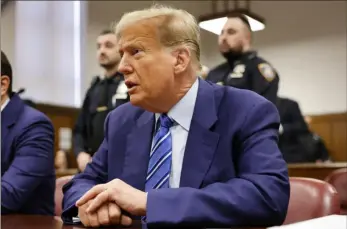  ?? Michael M. Santiago/AFP via Getty Images ?? Former President Donald Trump attends the second day of his trial for allegedly covering up hush money payments linked to extramarit­al affairs, at Manhattan Criminal Court in New York City on Tuesday.