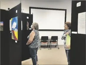  ?? PHOTO COURTESY YUMA COUNTY LIBRARY DISTRICT ?? FOOTHILLS LIBRARY PATRONS take in the annual Art & Poetry Exhibition. The exhibit returns to the library at 13226 E. South Frontage Road March 7-11.