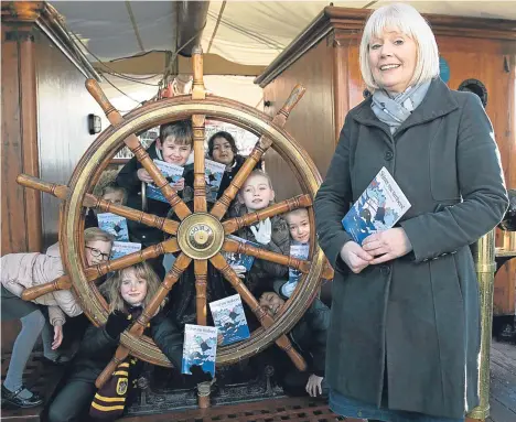  ??  ?? CHILDREN from Rosebank Primary School in Dundee wrapped up Book Week Scotland with a storytime with a difference — on board the famous ship RRS Discovery.
Braving icy weather just like Captain Scott and his crew as the temperatur­es dipped below zero,...