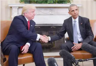  ?? — AFP photos ?? In this file photo taken on Nov 10, 2016, US President Barack Obama and President-elect Donald Trump shake hands during a transition planning meeting in the Oval Office at the White House in Washington.