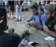  ?? PICTURE: KARINDA JAGMOHAN ?? University students gather around cafeteria tables to play the Durban-born game thunee, with skills passed on to them by their families and friends.