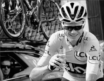  ?? Christophe Ena/Associated Press ?? Britain's Chris Froome celebrates with a glass of Champagne during the final stage of the Tour de France Sunday in Paris.