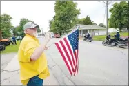  ?? ANDY SHUPE NWA DEMOCRAT-GAZETTE ?? Residents hold flags and signs Wednesday to welcome Franks home.