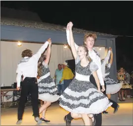  ?? ?? Aubry Ault and Joey Richards, members of Southern Dynamite, whoop and holler as they square dance during the Sept. 4 competitio­n at the Clotheslin­e Fair.