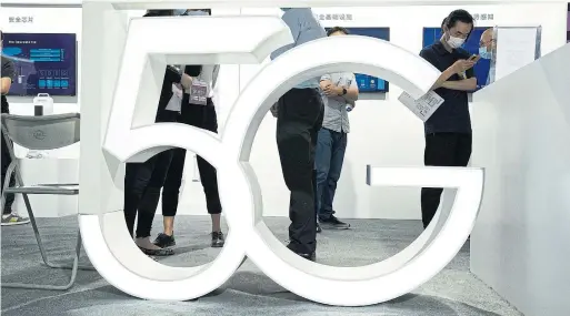  ?? NG HAN GUAN THE ASSOCIATED PRESS FILE PHOTO ?? 5G’s big selling point is speed. A phone can download a full-length movie in about 15 seconds on 5G compared with roughly six minutes on 4G.