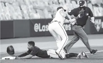  ?? ERIC GAY AP ?? Magneuris Sierra slides safely into third base past Atlanta’s Austin Riley in the third inning. Sierra went on to score and had two hits in the game subbing for injured center fielder Starling Marte.